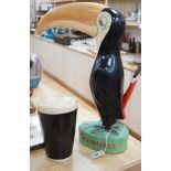 A large composition Guinness toucan, 66cm, and related pint ornament