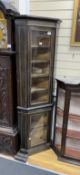 A late 19th century French ebonised two sectional glazed standing corner cabinet, width 61cm,