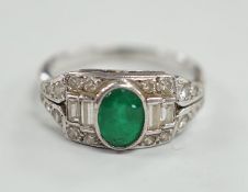 An Art Deco white metal, singe stone oval cut emerald and round and baguette cut diamond cluster set