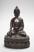 A Chinese bronze Buddha, on lotus base, 20cms high
