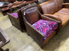 A pair of early 20th century studded tan leather armchairs, width 66cm, depth 76cm, height 88cm