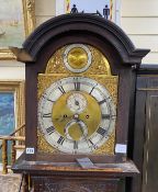 An 18th century oak 8 day longcase clock, with later carved decoration, the silvered chapter ring