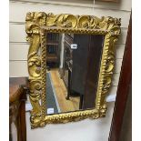 A Florentine style carved and pierced scrolling acanthus framed wall mirror, width 53cm, height