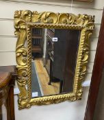 A Florentine style carved and pierced scrolling acanthus framed wall mirror, width 53cm, height