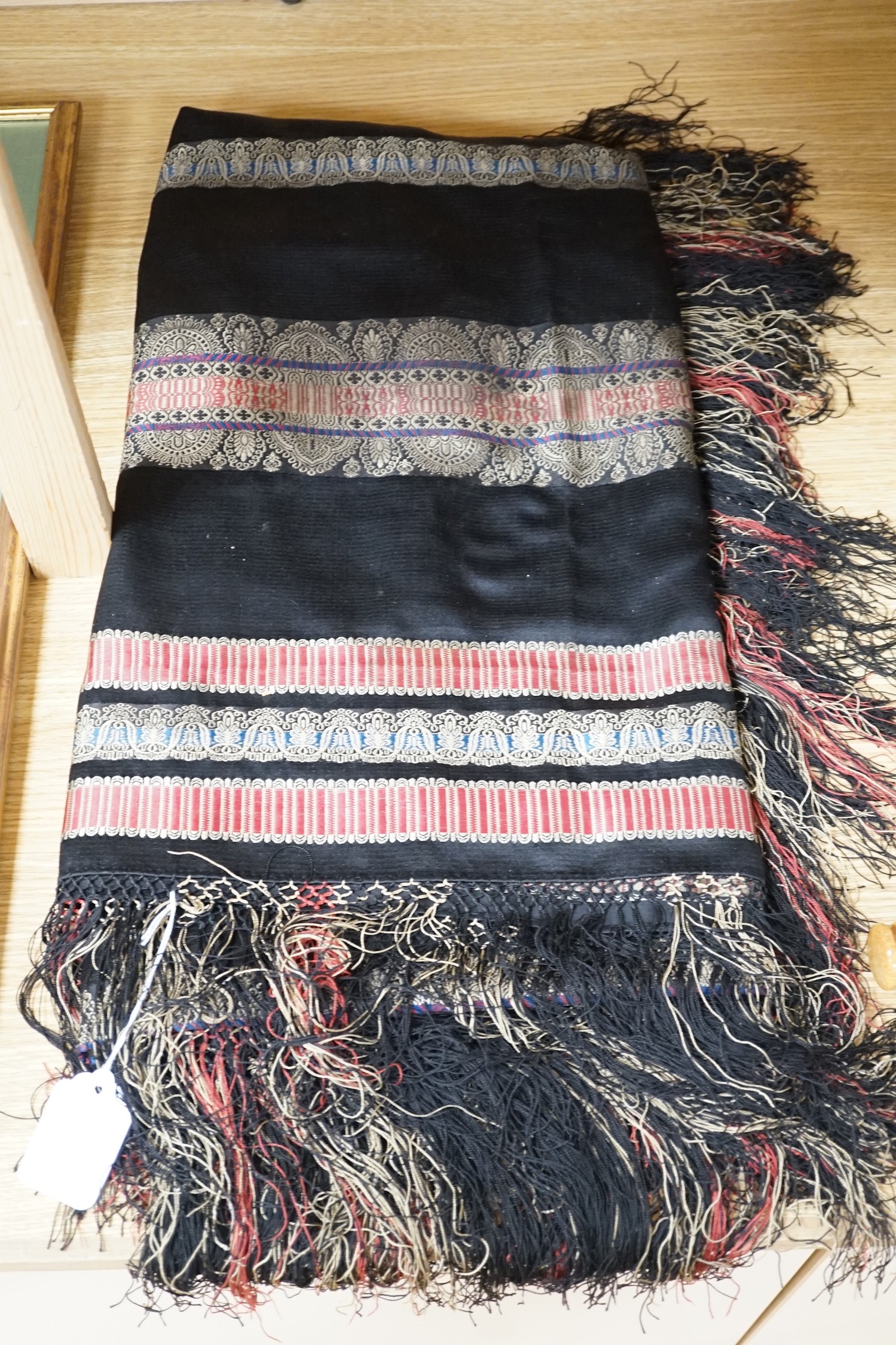 A Victorian black silk shawl woven, woven with multi-coloured Paisley designed stripes bordered with - Image 2 of 4