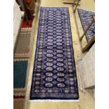 A Bokhara style blue ground runner, 230 x 76cm