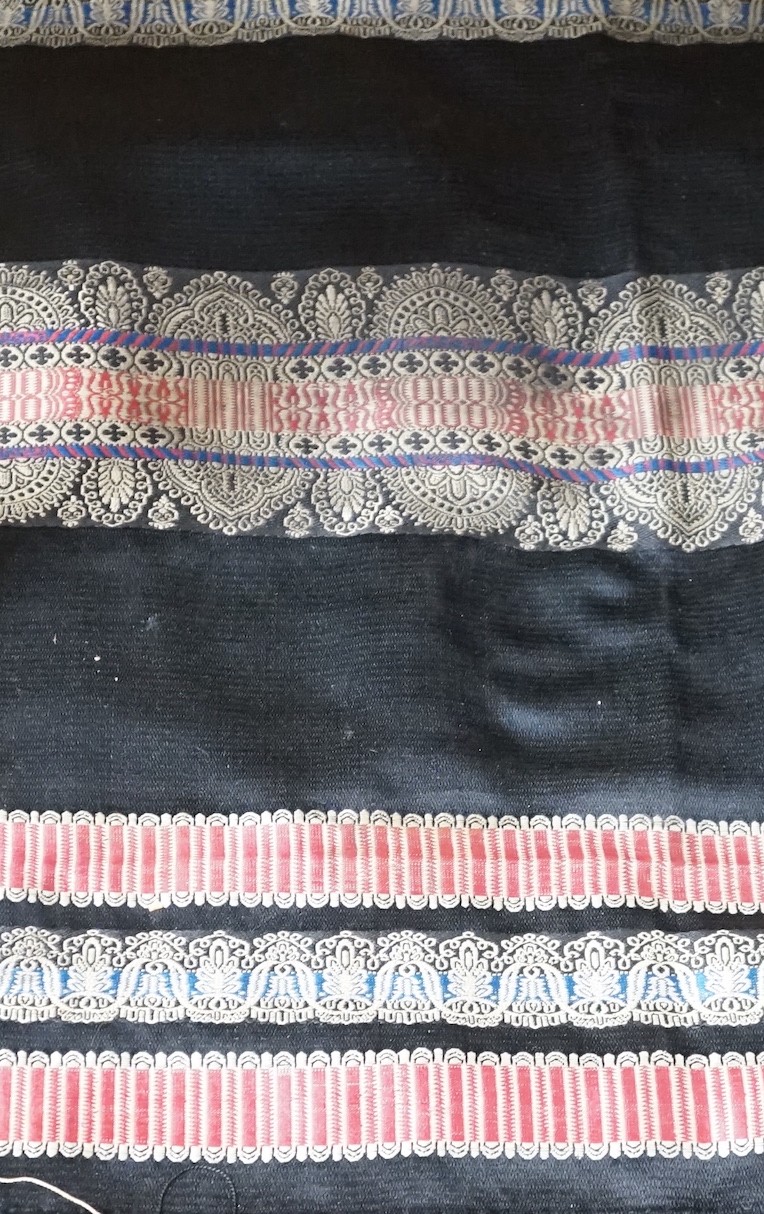 A Victorian black silk shawl woven, woven with multi-coloured Paisley designed stripes bordered with