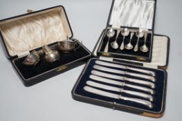 A cased George V three piece silver condiment set, Birmingham, 1928 and two other cased sets of