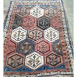 An early 20th century Caucasian blue ground rug woven rows of hexagonal medallions,162 x 124cm