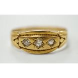 A late Victorian 18ct gold and gypsy set three stone diamond ring, size Q, gross weight 2.8 grams.