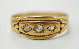 A late Victorian 18ct gold and gypsy set three stone diamond ring, size Q, gross weight 2.8 grams.