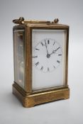 A 19th century French chased gilt brass cased carriage clock with black Roman dials and second