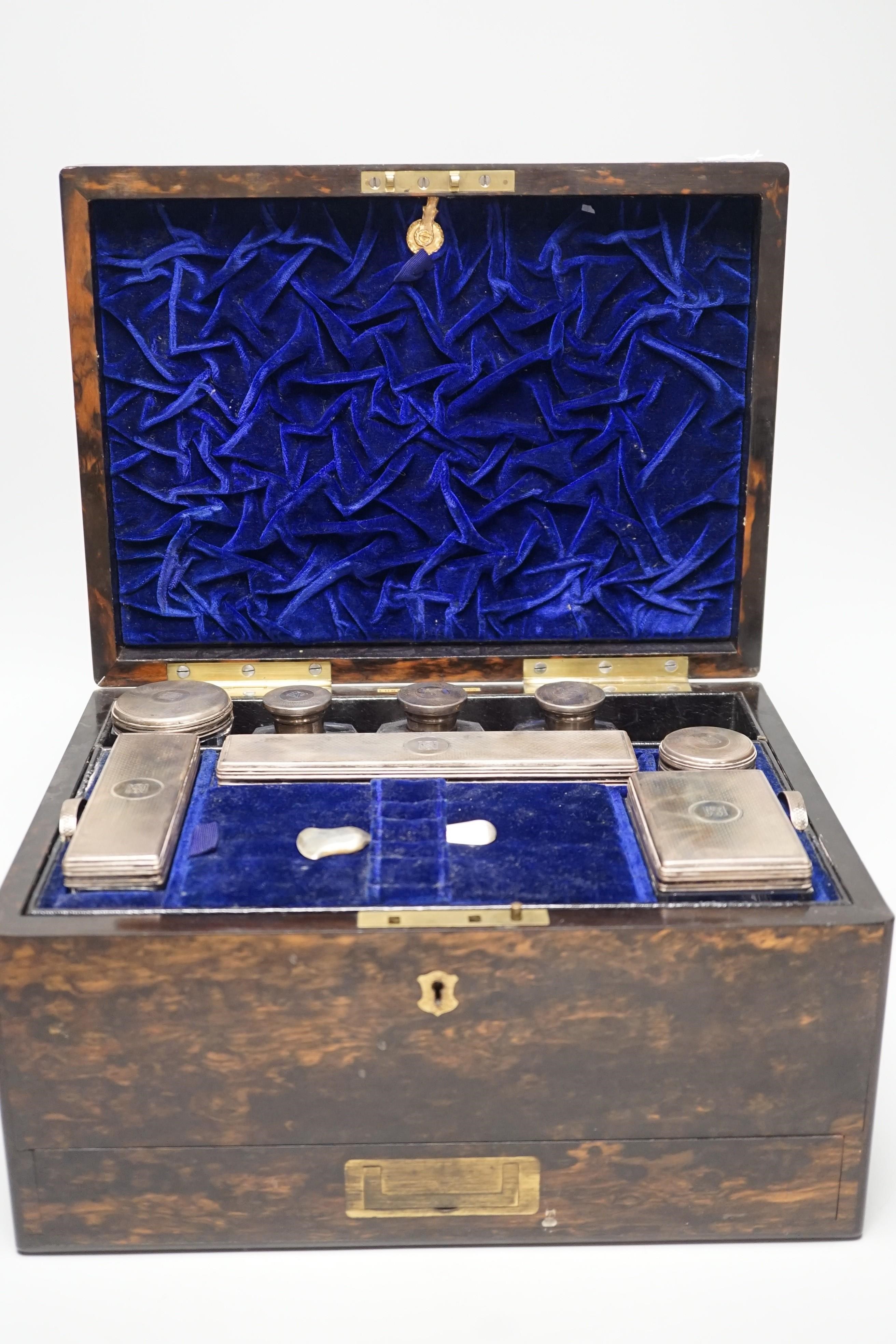 A Victorian brass mounted coromandel wood travelling toilet box, containing eight silver mounted