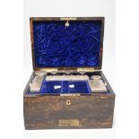 A Victorian brass mounted coromandel wood travelling toilet box, containing eight silver mounted