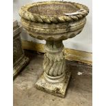 A circular reconstituted bird bath, diameter 40cm, height 65cm