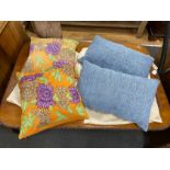 Two pairs of polychrome floral embroidered and blue woven cushions, larger 50cm square.