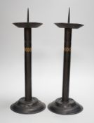 Attributed to Glasgow School of Art - a pair of Arts and Crafts pricket candlesticks. 40cm tall