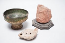 A Roman green glazed vessel, 13 cm wide and a pottery oil lamp, with letter of provenance dated 1942