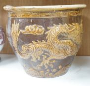 A Chinese Brown and treacle glazed dragon planter. 32cm tall