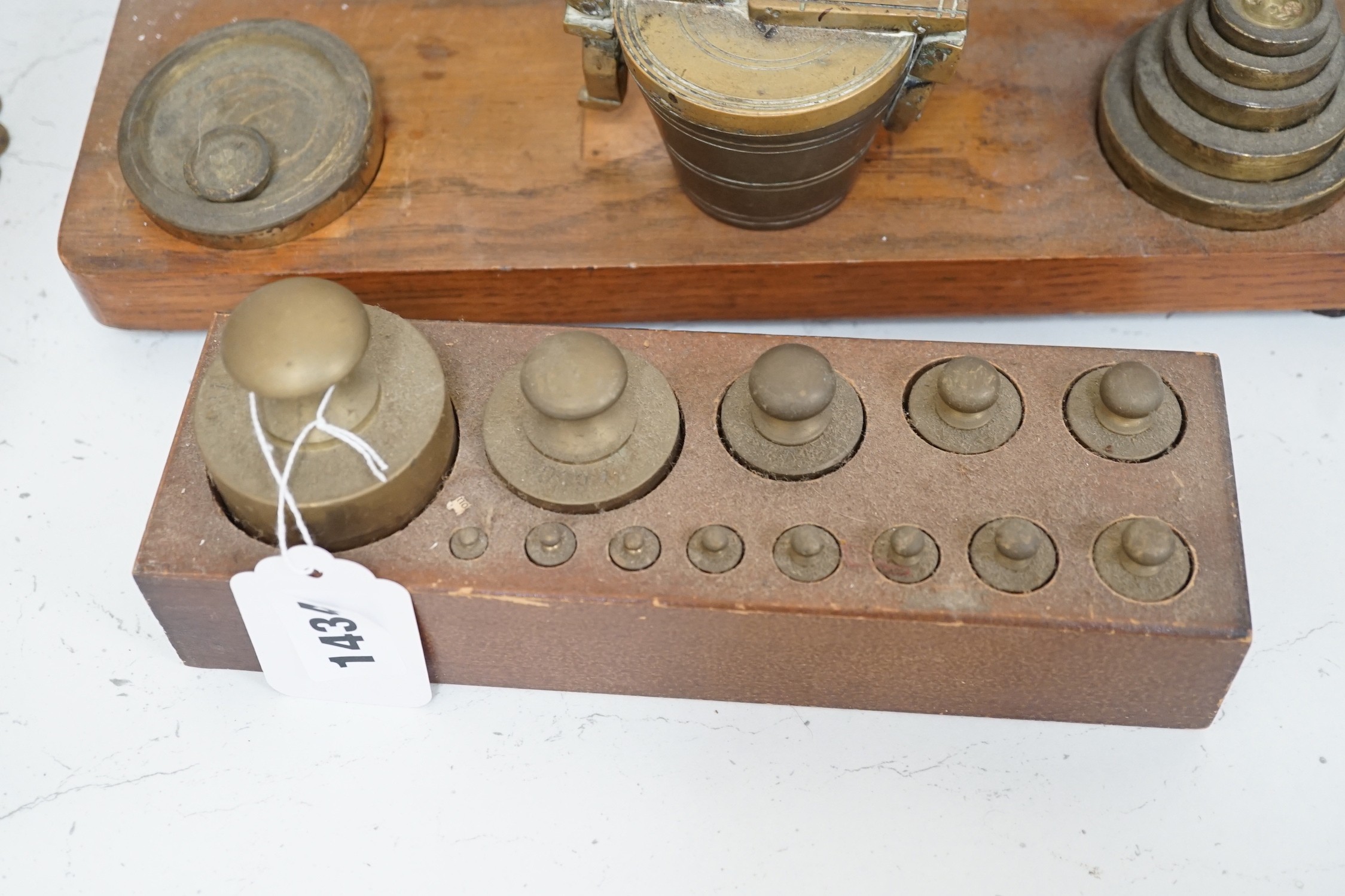 ° ° A set of brass postal scales and weights, a separate set of weights and another, set in wooden - Image 2 of 3