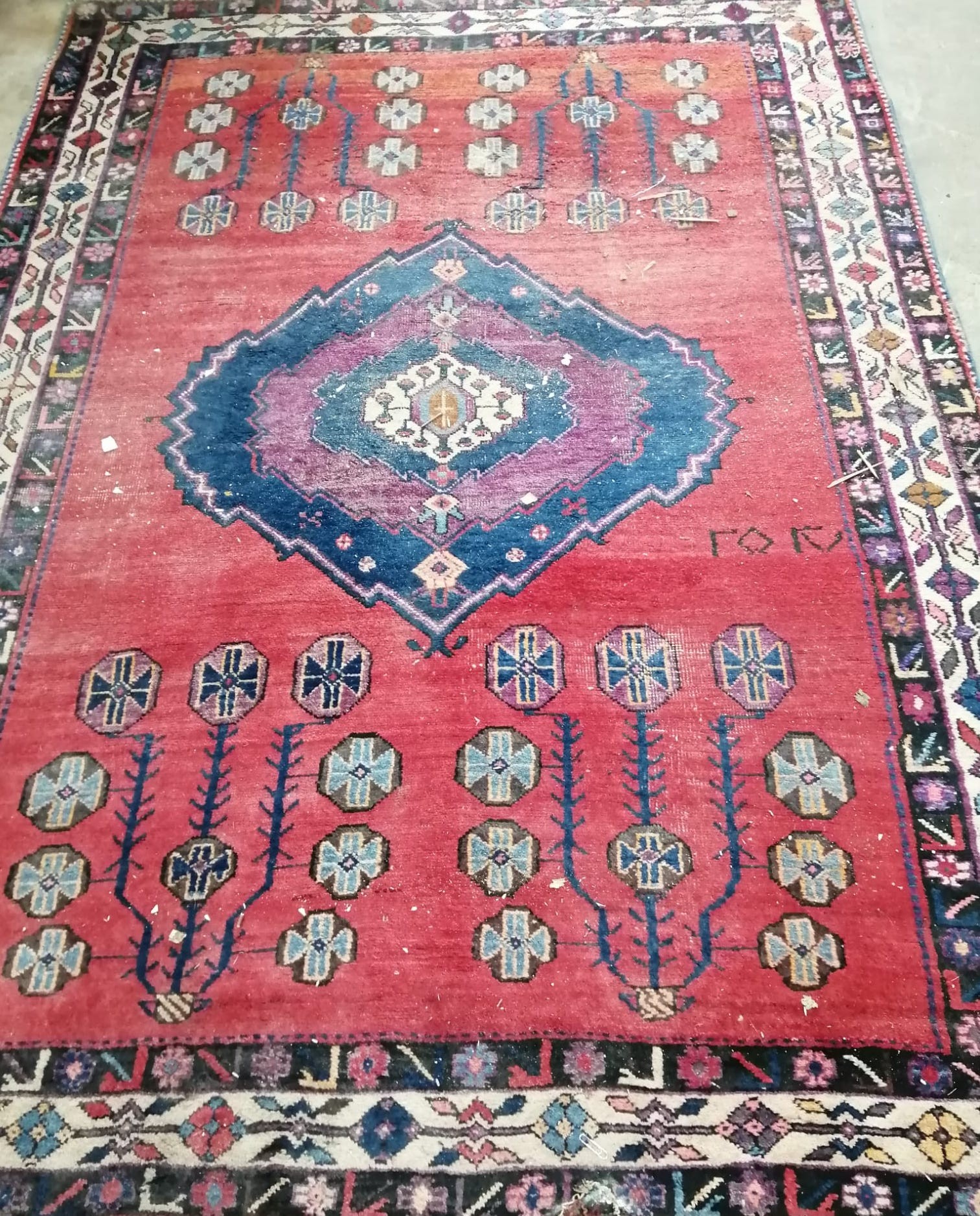 An early 20th century Turkish red ground rug with central stepped medallion, 212 x 156cm