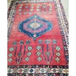 An early 20th century Turkish red ground rug with central stepped medallion, 212 x 156cm