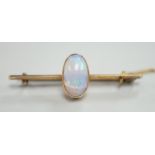 A yellow metal and single stone oval white opal set bar brooch, 39mm, gross weight 4.3 grams.