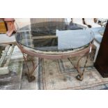 A wrought iron glass topped circular cartwheel garden table, diameter 124cm, height 72cm