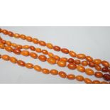 A long single strand graduated oval amber bead necklace(string broken), 142cm, gross weight 51