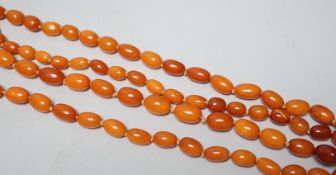 A long single strand graduated oval amber bead necklace(string broken), 142cm, gross weight 51