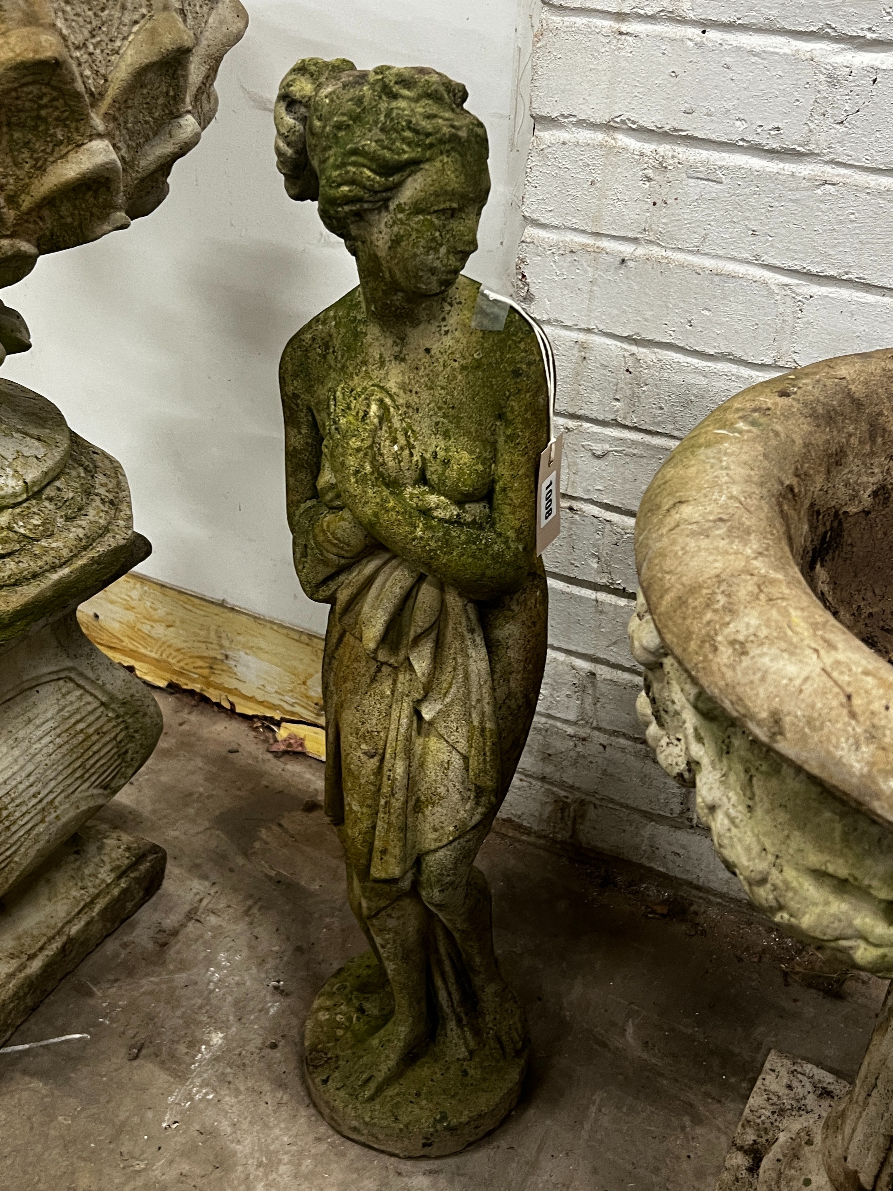 A reconstituted stone female bather garden ornament, height 80cm