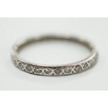 A white metal and diamond chip set full eternity ring, size K, gross weight 1.8 grams.