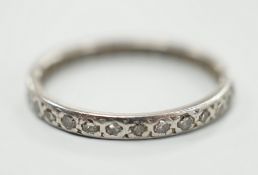 A white metal and diamond chip set full eternity ring, size K, gross weight 1.8 grams.