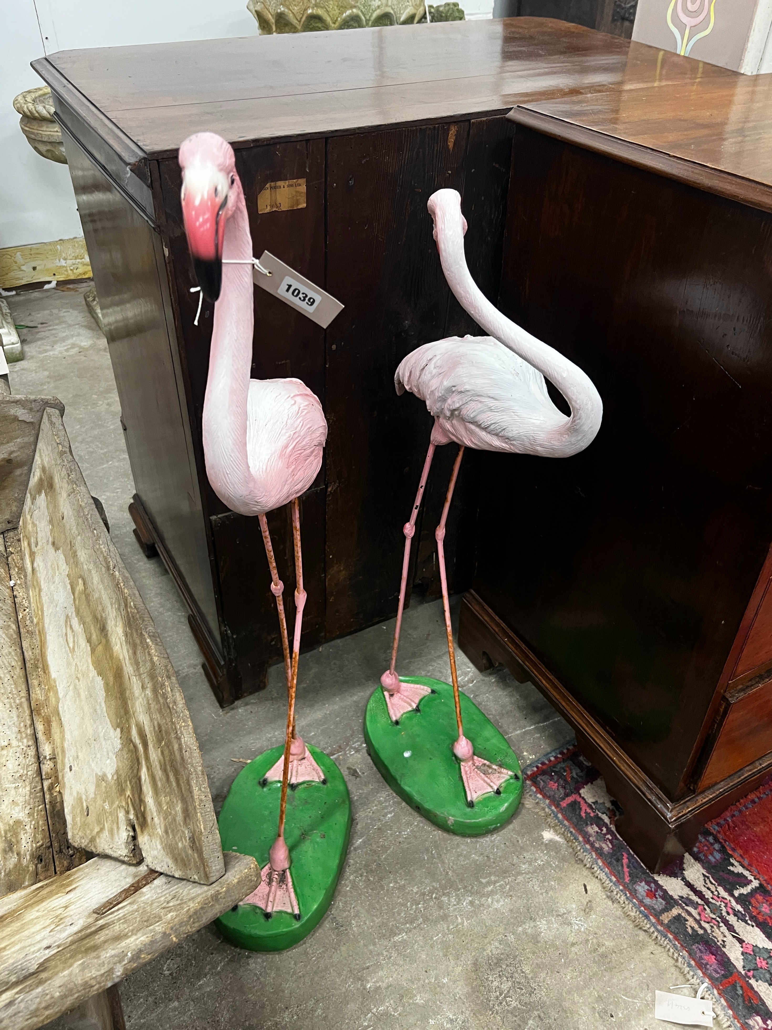 A pair of flamingo garden ornaments, larger height 103cm