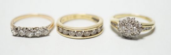 Two modern 18ct gold and diamond set rings, including nine stone channel set, size L and diamond