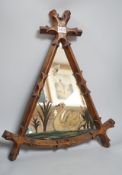 A reformed Gothic oak framed ‘swan’ painted mirror, 55cm tall