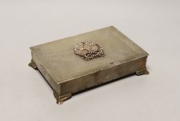 An Elizabeth II engine turned silver rectangular cigarette box, with yellow metal applique and