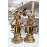 A pair of gilt spelter groups of a classical maiden and cherub, 61cm tall