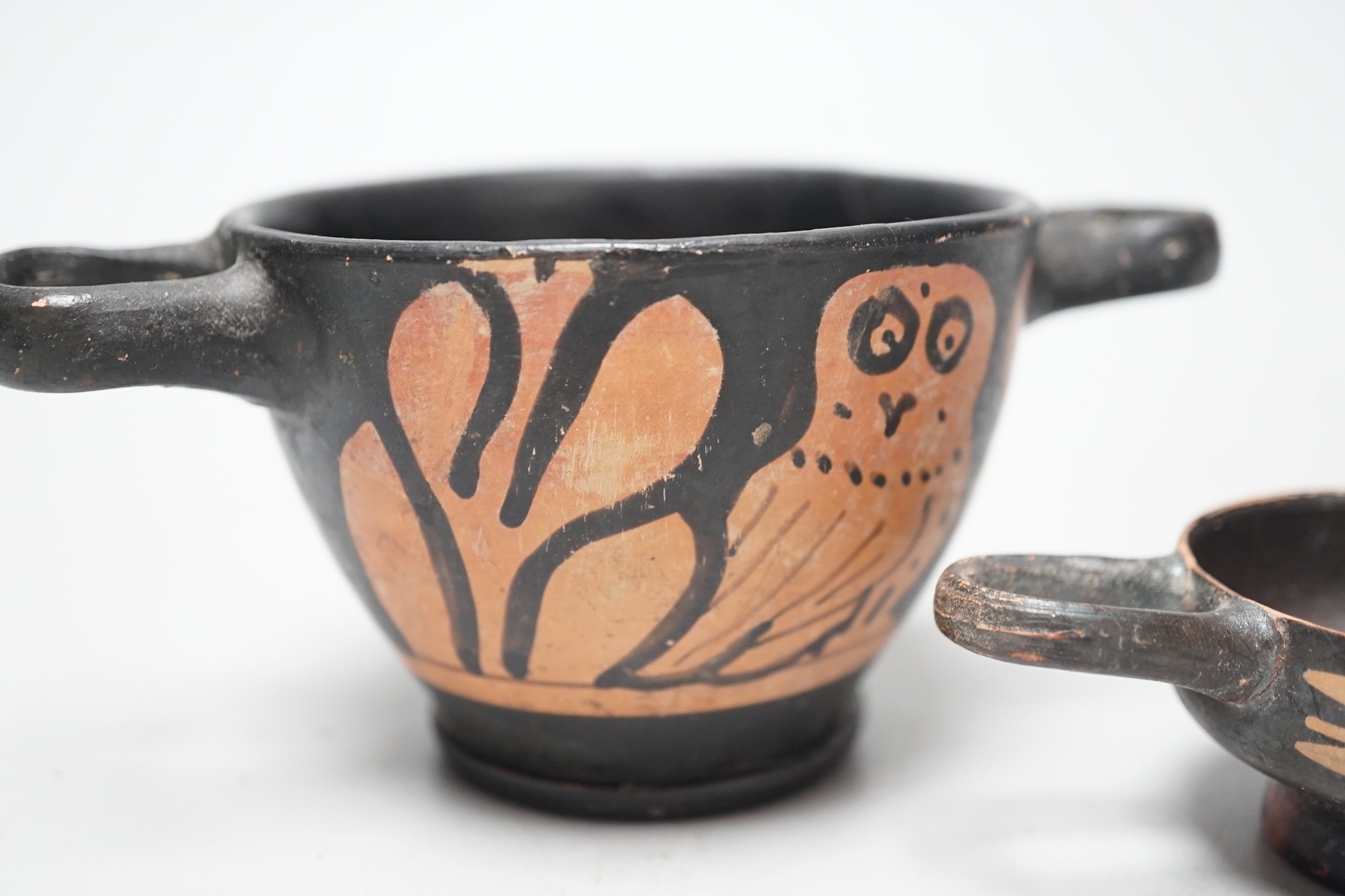 A 4th century B.C. South Italian Greek red figure owl skyphos, together with another similar smaller - Image 3 of 4