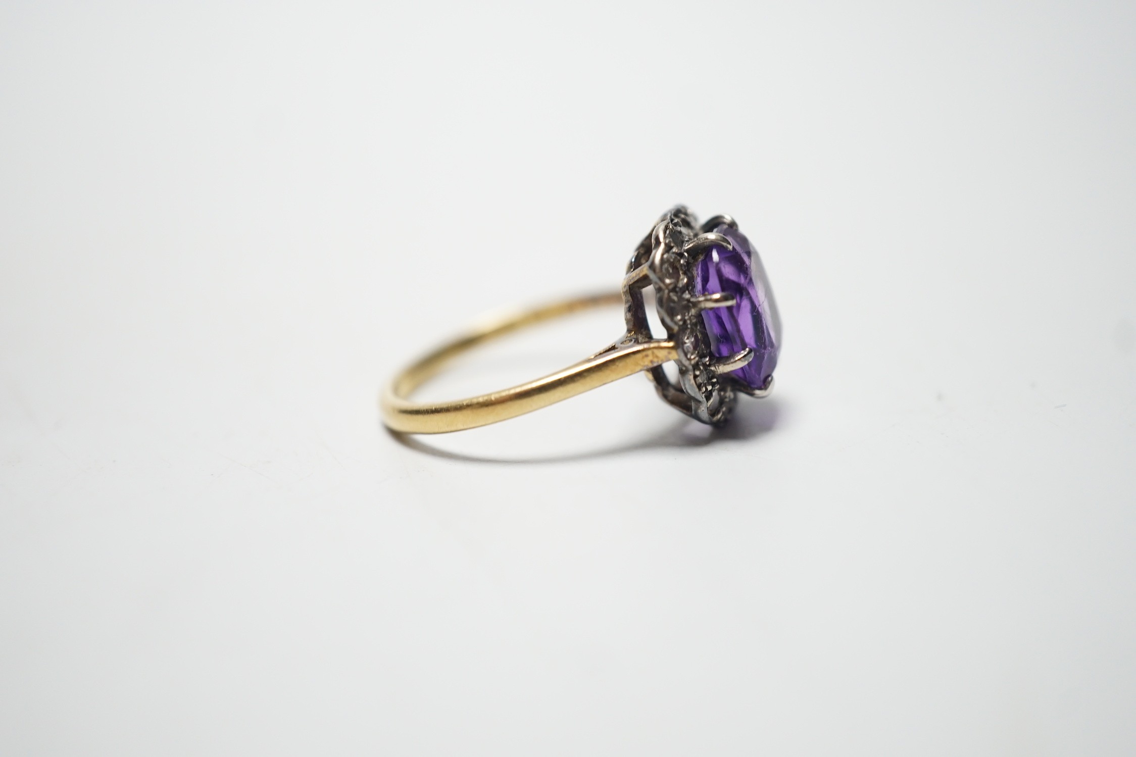 An 18ct, amethyst and diamond set oval cluster ring, size P, gross weight 4.5 grams. - Image 3 of 4
