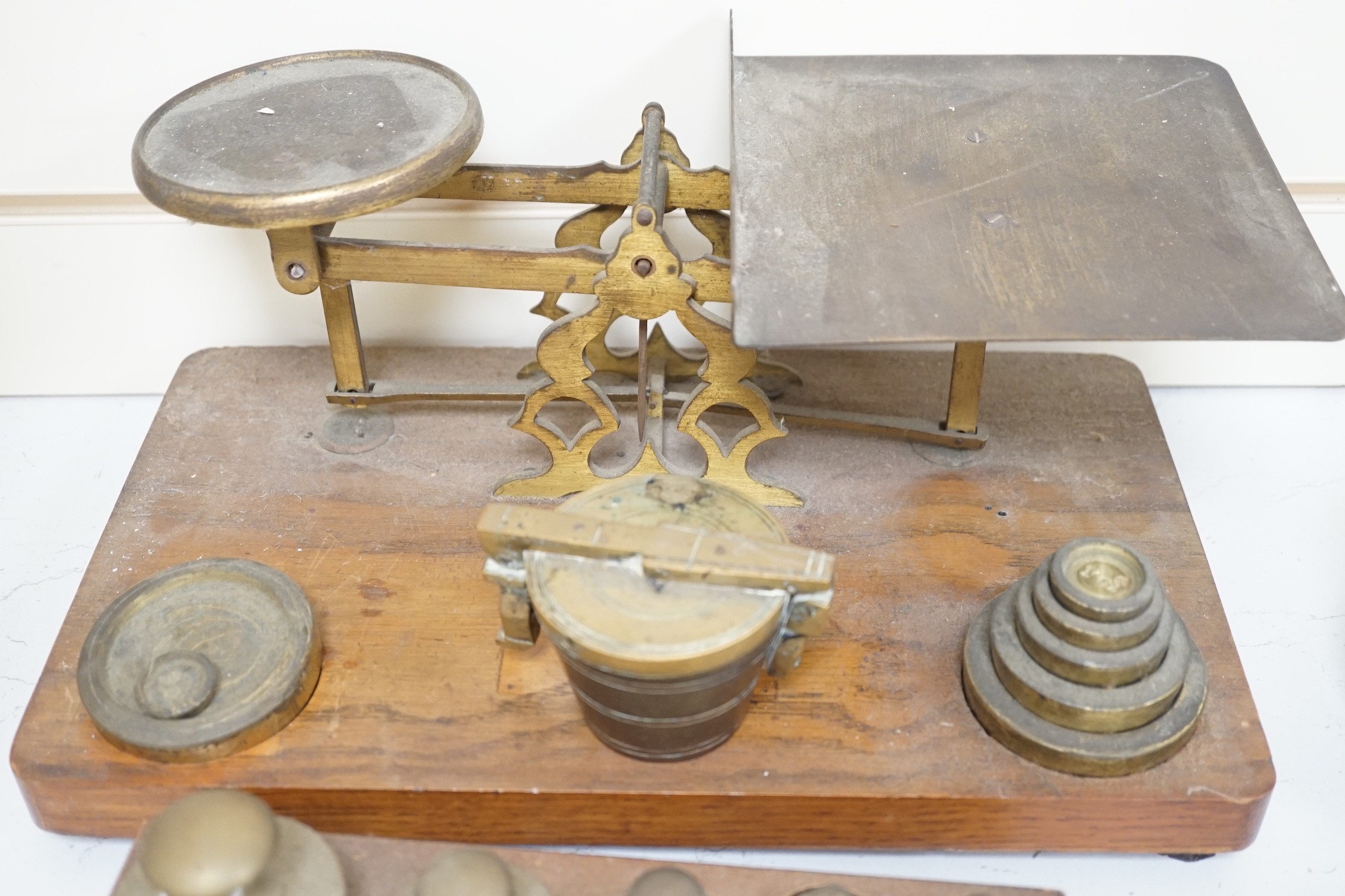° ° A set of brass postal scales and weights, a separate set of weights and another, set in wooden - Image 3 of 3