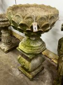 A reconstituted stone circular garden planter on square plinth, diameter 52cm, height 89cm