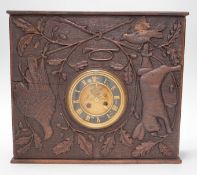 A late 19th century / early 20th century folk art carved oak cased clock, decorated with hanging