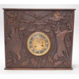 A late 19th century / early 20th century folk art carved oak cased clock, decorated with hanging
