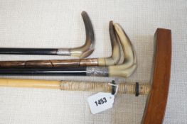 Three horn handled walking sticks and a polo mallet, Longest 138cm