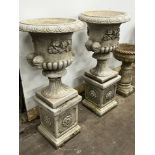 A pair of reconstituted stone campana garden urns on square pedestals, diameter 49cm, height 108cm