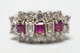 A modern 18ct white gold, square cut ruby and round and baguette cut diamond set cluster ring,