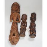 A carved teak terminal figure and two African tribal figures, largest 32cm long