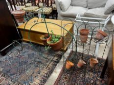 A wrought iron bicycle pot stand, height 98cm together with a pair of folding wirework pot stands