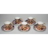 Five Royal Crown Derby Imari coffee cans and saucers